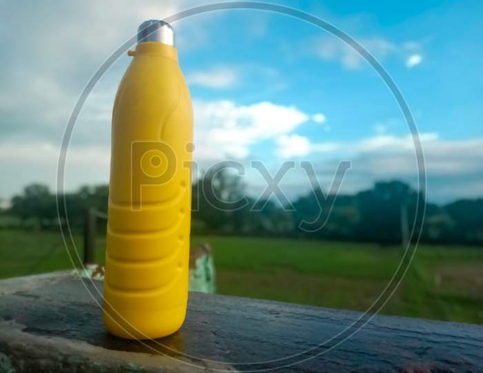 Yellow colour water bottle with natural background