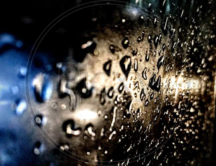 Rain drops on car window glass