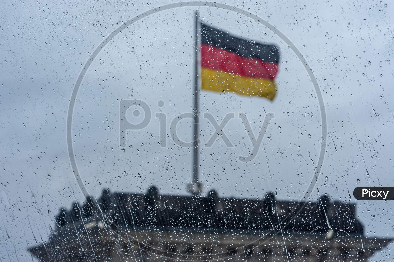 Raindrops On The Window With German Flag In Soft Focus In The Background