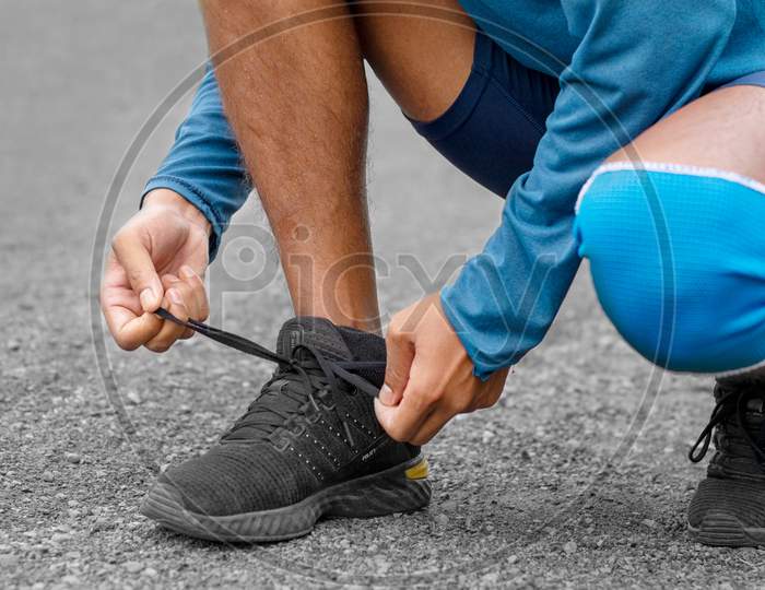 Close Of Athlete Is Shoe Lacing For Being Ready To Exercise.