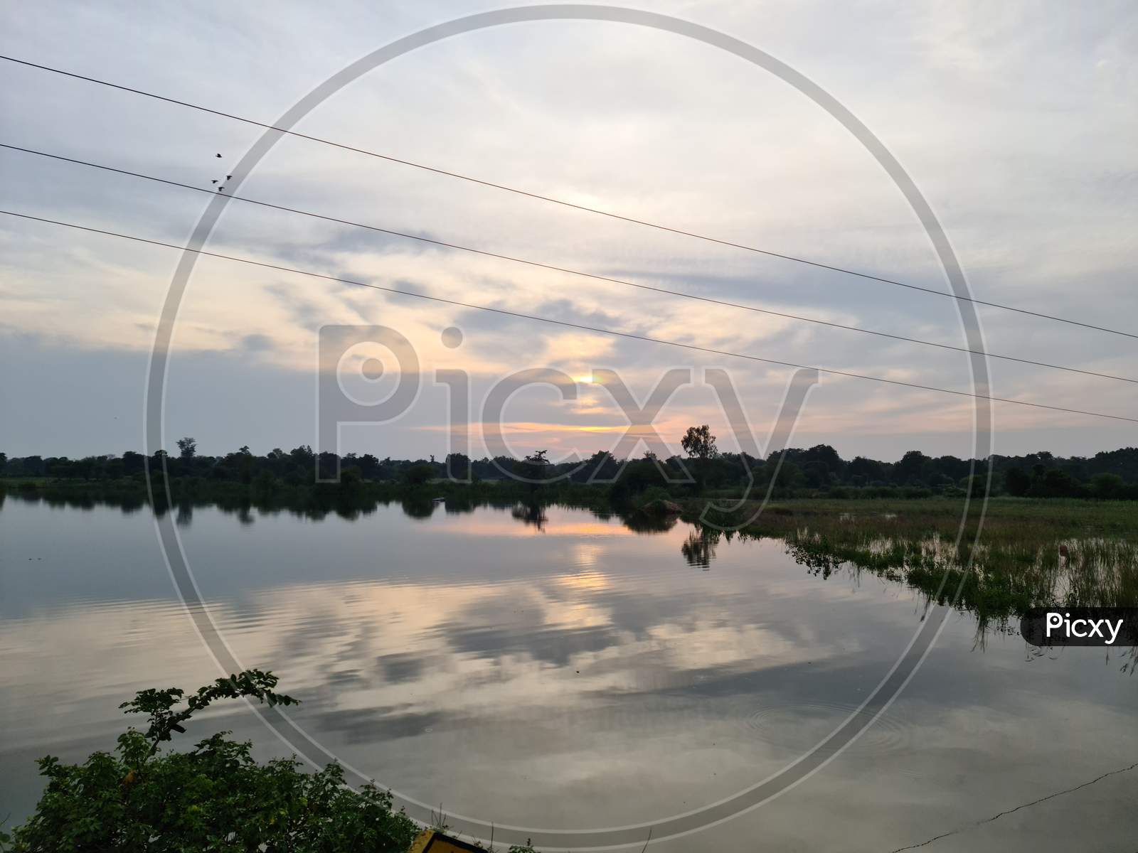Photo of pond with sunset reflection