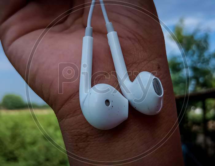 Headphones holding in a hand