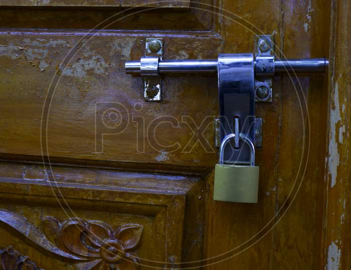 Close Shot Of Locked Padlock Isolated On Wooden Door