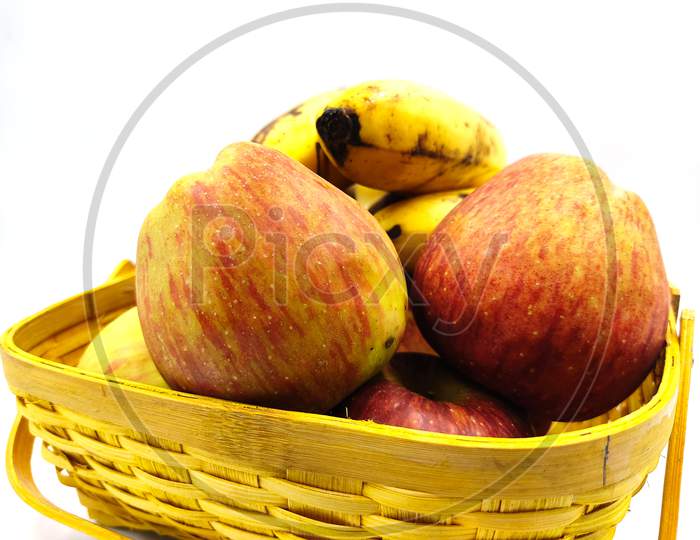 fresh fruits in basket isolated on white background