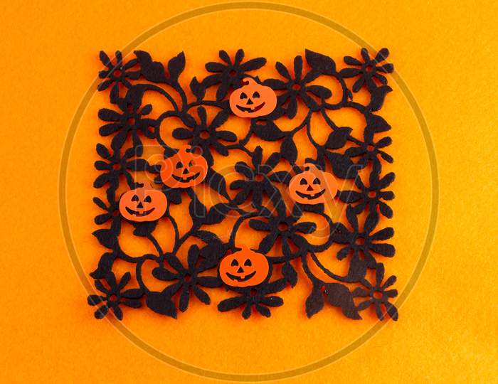 5 Grinning Halloween Pumpkins On Black Floral Silhouette On Orange Background
