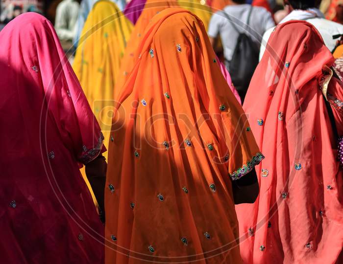 A group of Indian women wearing traditional clothes with vibrant colors at Pushkar, Rajasthan, India