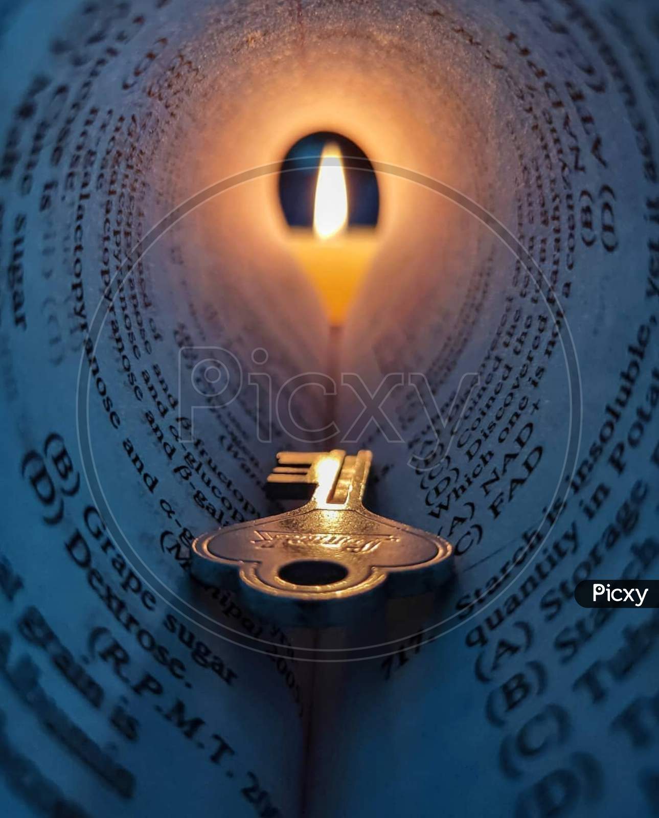 Very beautiful creation by using a key, candle and a rolled paper