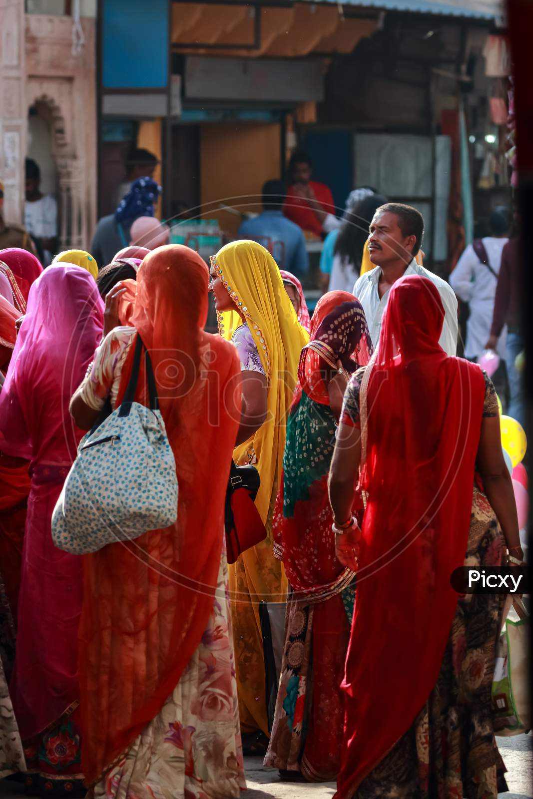 A group of Indian women wearing traditional clothes with vibrant colors at Pushkar, Rajasthan, India