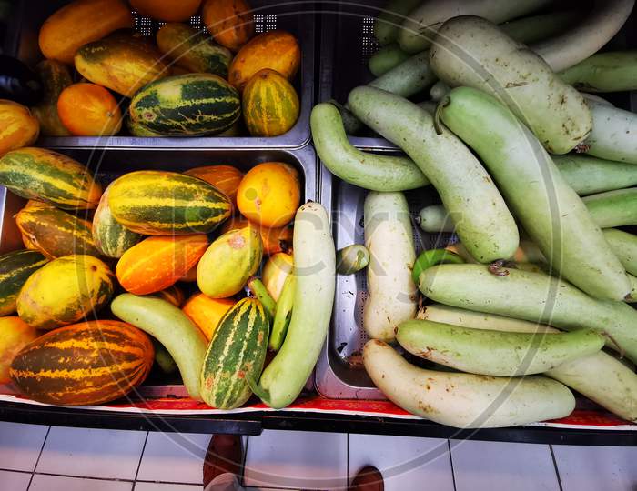 Yellow cucumber and bottle gourd vegetables in a market