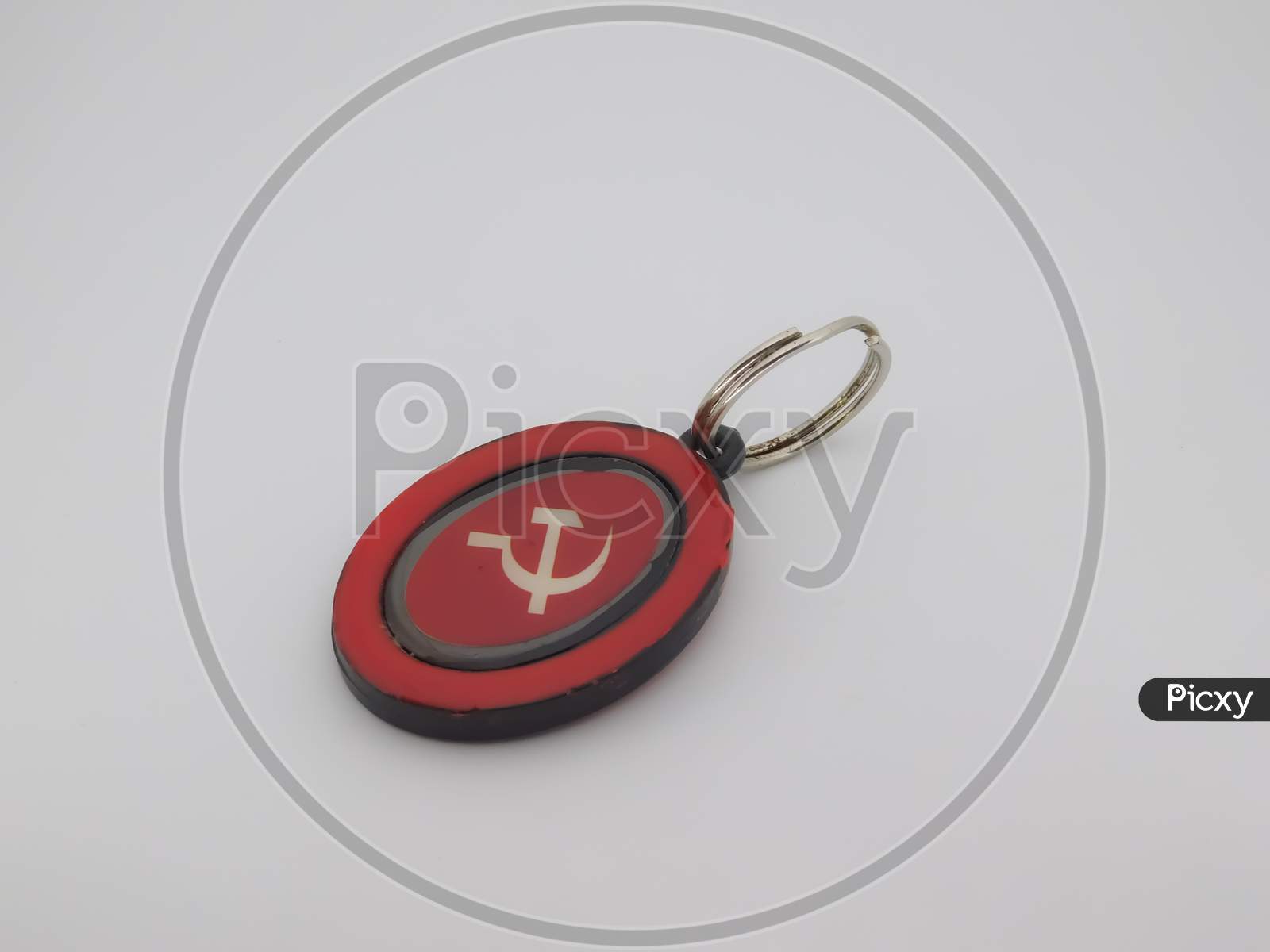 Closeup Of A Red Object Attached With A Ring Isolated On White Background