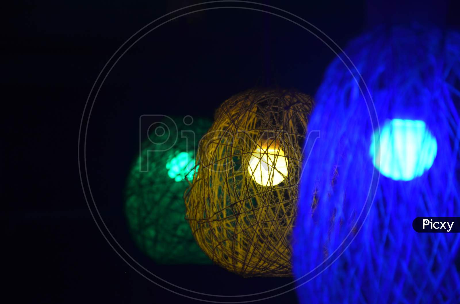Homemade coloured woolen lamp, selective focus,blurred background.