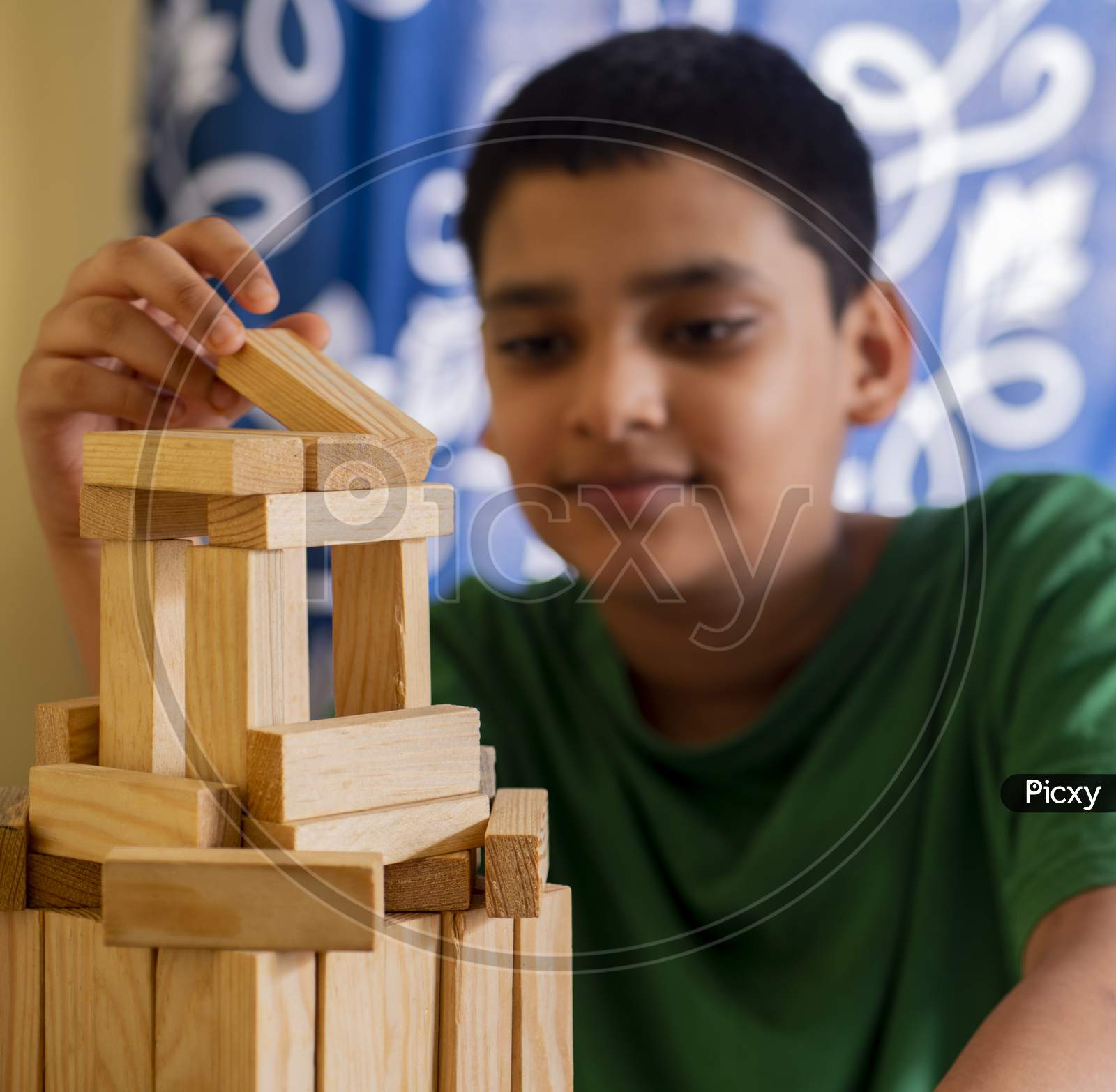 Boy Enjoying Building Castle From Wooden Blocks