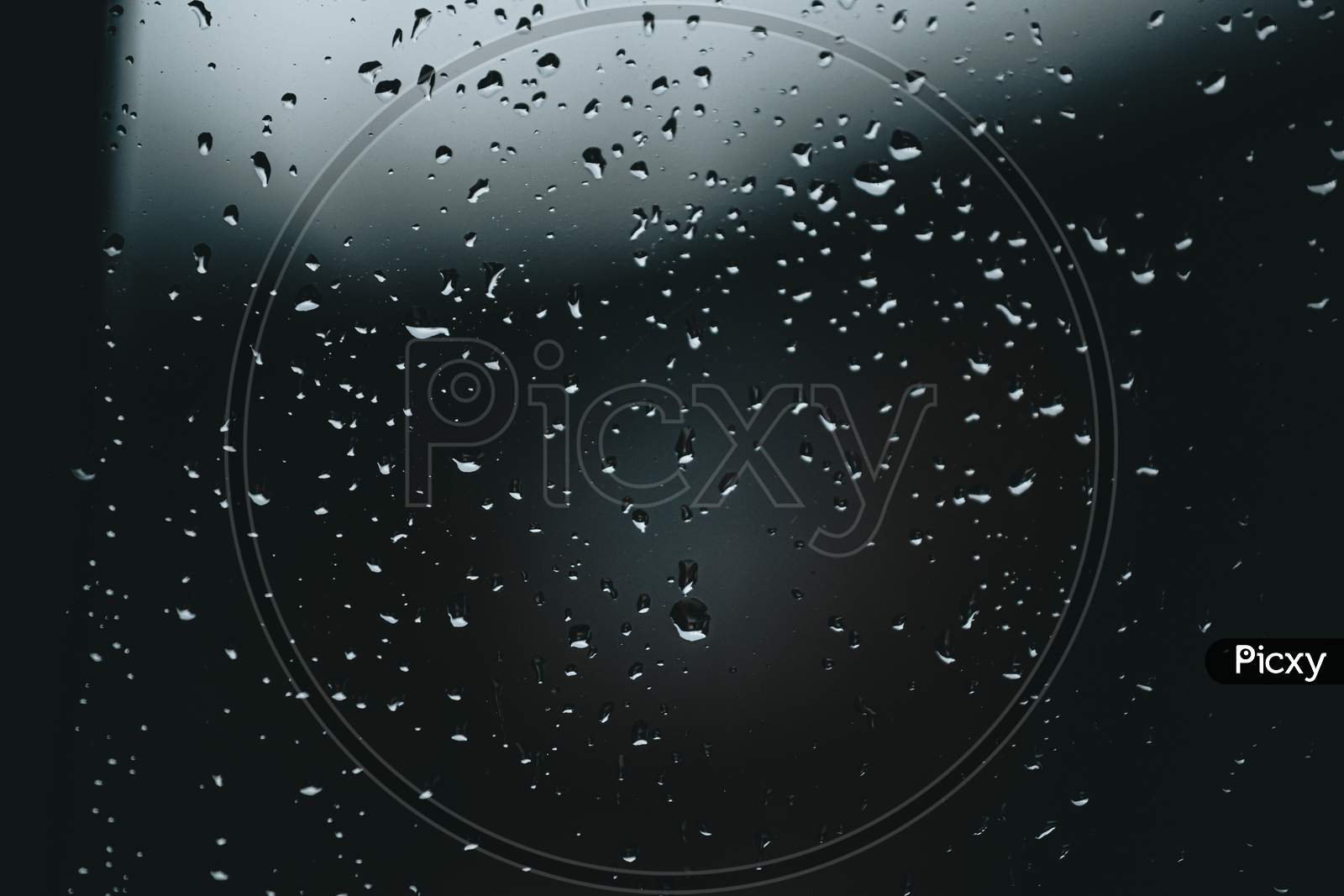 Horizontal Background Of Some Moody Rain Drops Over A Window With Dark Tones And Textured Droplets