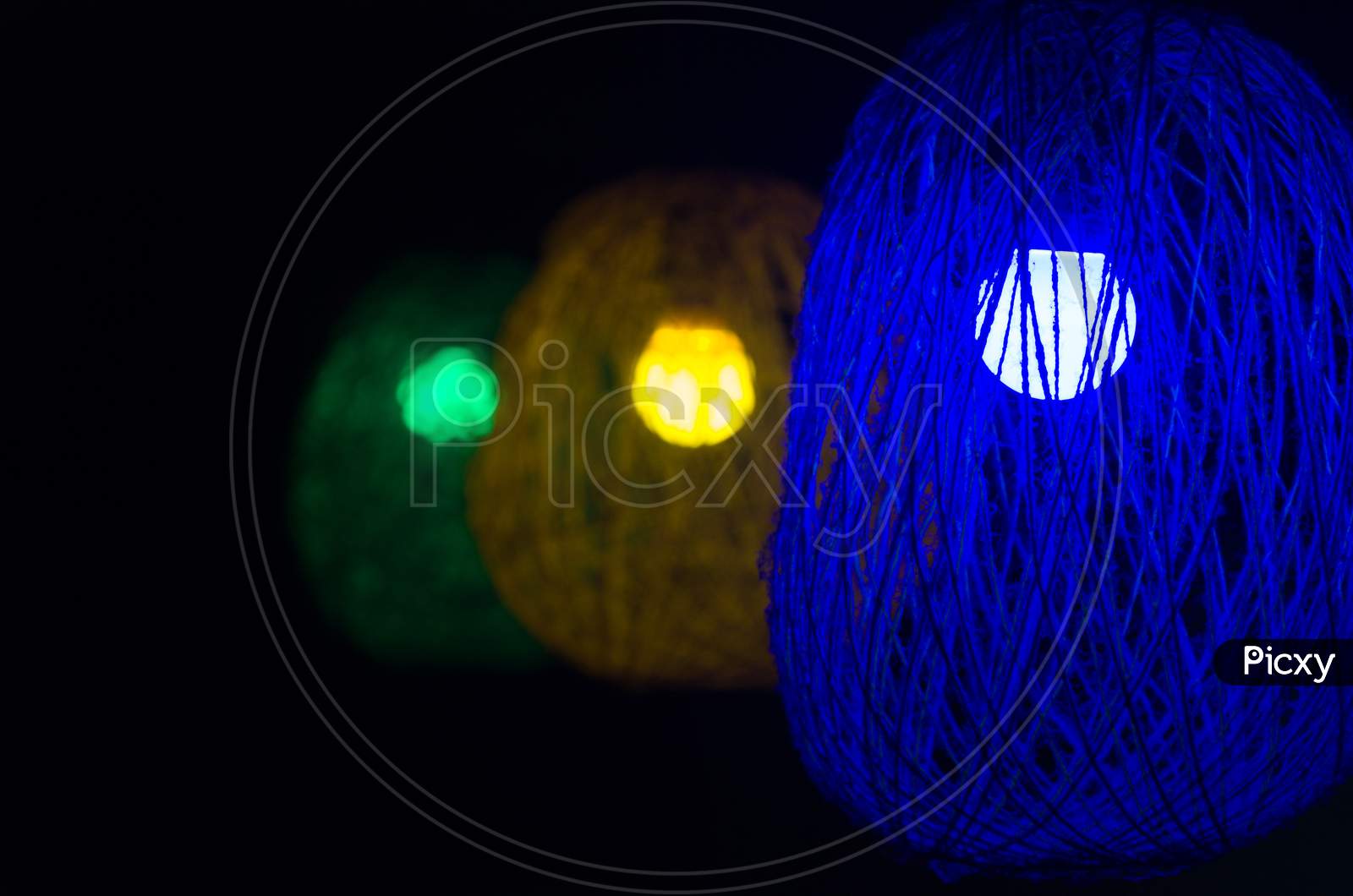 Homemade coloured woolen lamp, selective focus,blurred background.
