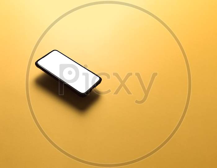 Minimalistic Mock Up Flat Image Design With A Floating Mobile Phone With Copy Space And White Scree To Write Over It Over A Flat Yellow Background