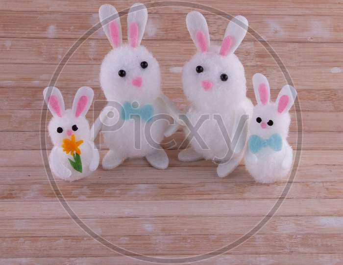 Cute Easter Bunny Family Of 4 Isolated On Wooden Background