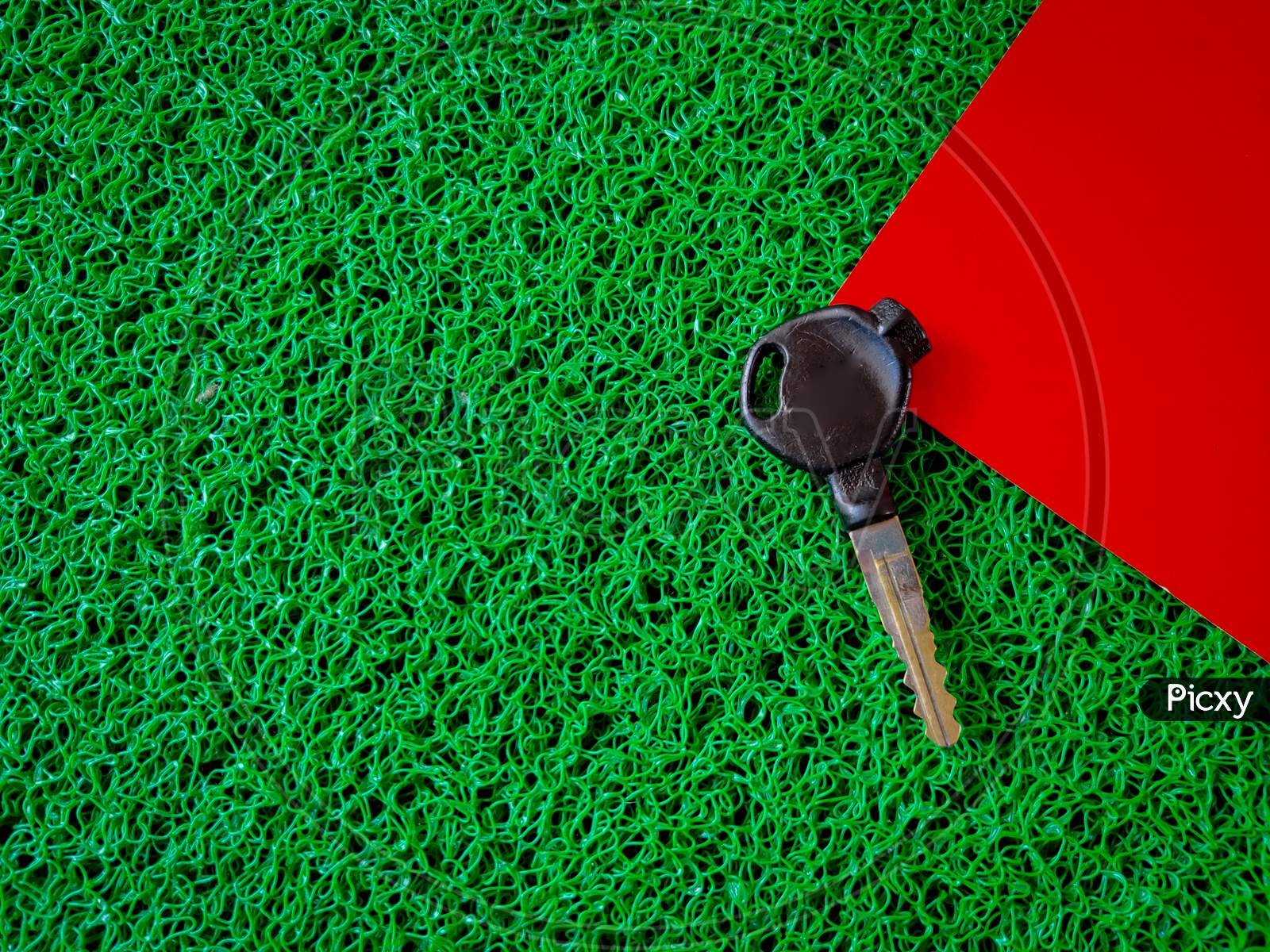 Top View Of Bike Key Isolated On Red And Green Background.