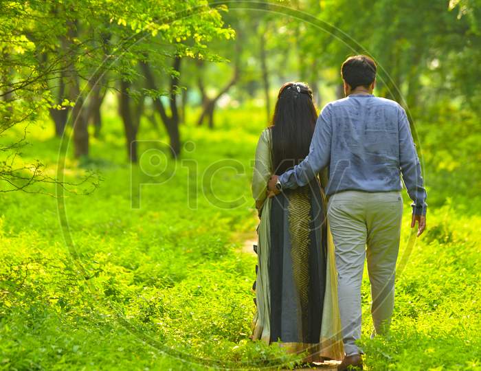 Young Indian Couple Walk In Nature .