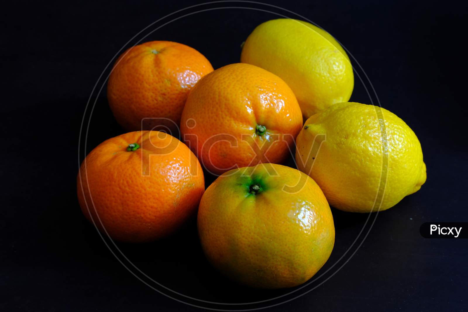 Lemon And Orange In Dark Background