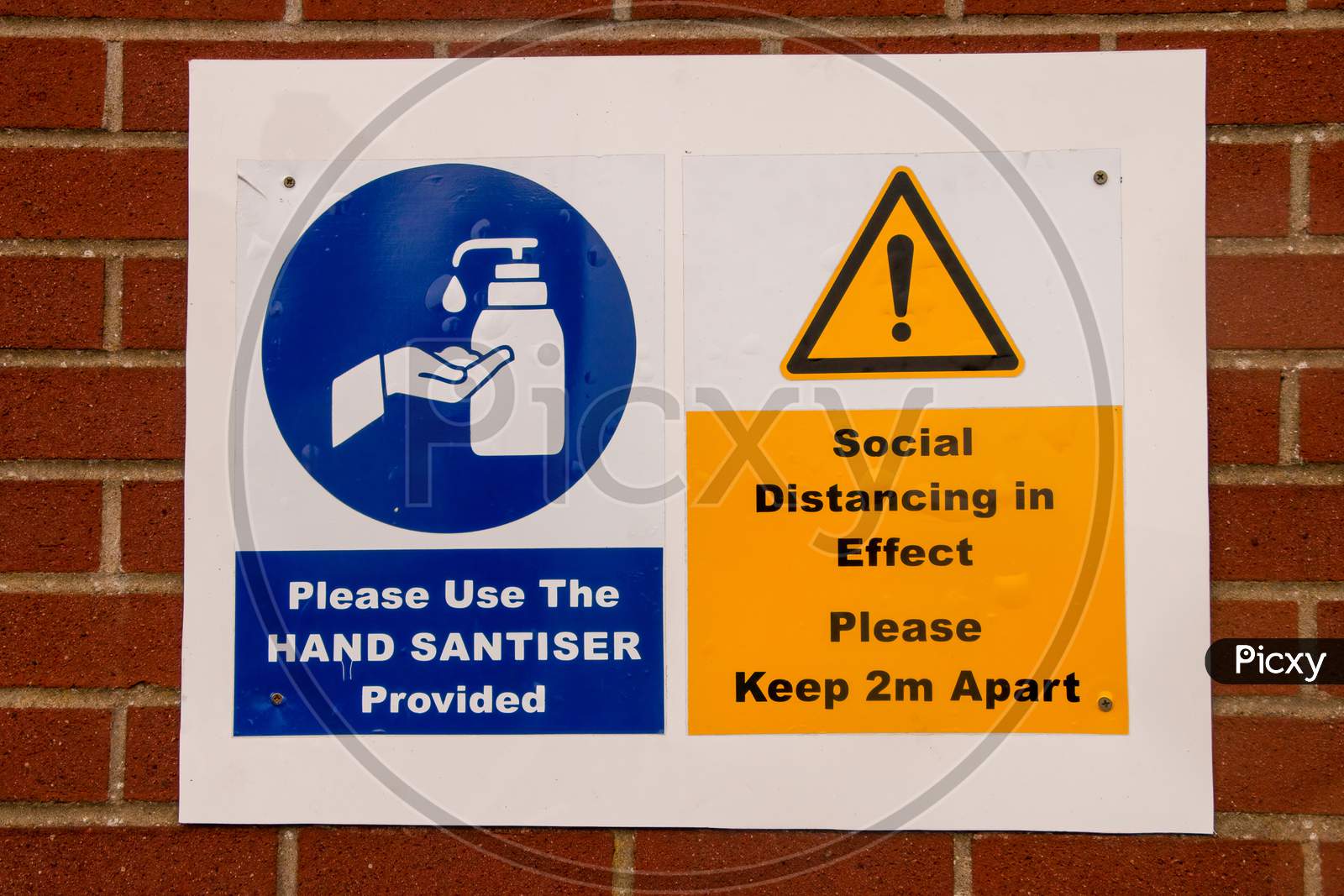 New Normal Warning Signs. Social Distancing Keep 2M Apart In Yellow And Use Hand Santiser Provided In Blue. Norfolk, UK - October 4th 2020