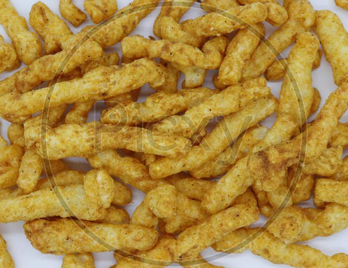 Healthy crunchy snack,Kurkure snack,Evening Snack or the Tea Snack,Kurkure is an evening snack that is manufactured using edible ingredients like rice meal, Background Texture.