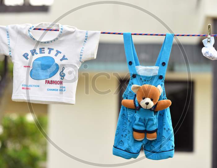 Baby Clothes Hanging On The Clothesline. Outdoor Concept .
