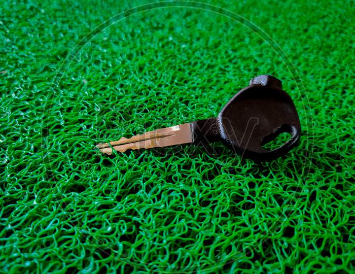 Side View Of Bike Key Isolated On Green Background.