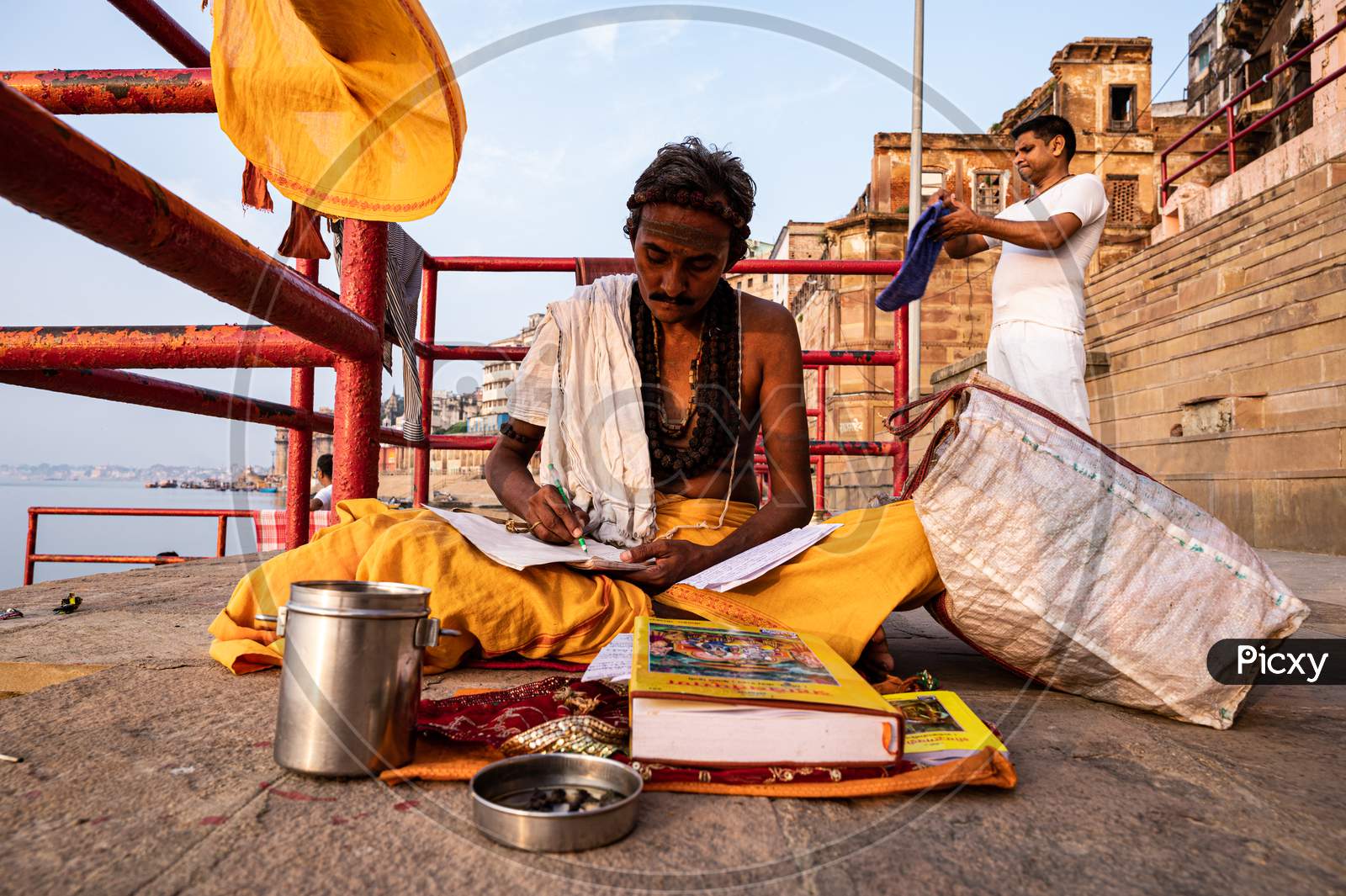 A monk chanting ram charitmanas at varanasi ghat