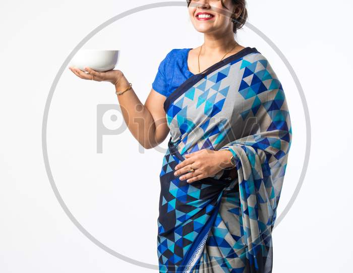 Indian Asian Woman Or Housewife Presenting White Ceramic Plate Or Bowl