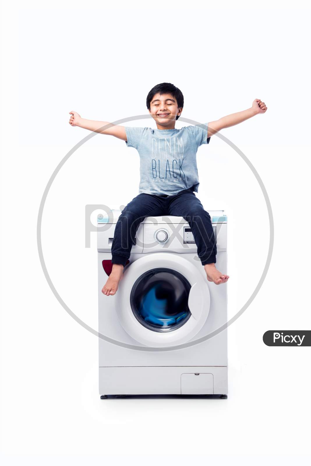 Indian Small Boy Presenting Dish Washer Or Washing Machine