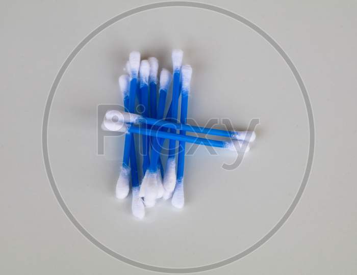 Blue Color Ear Cleaning Buds In Packets Against White Background
