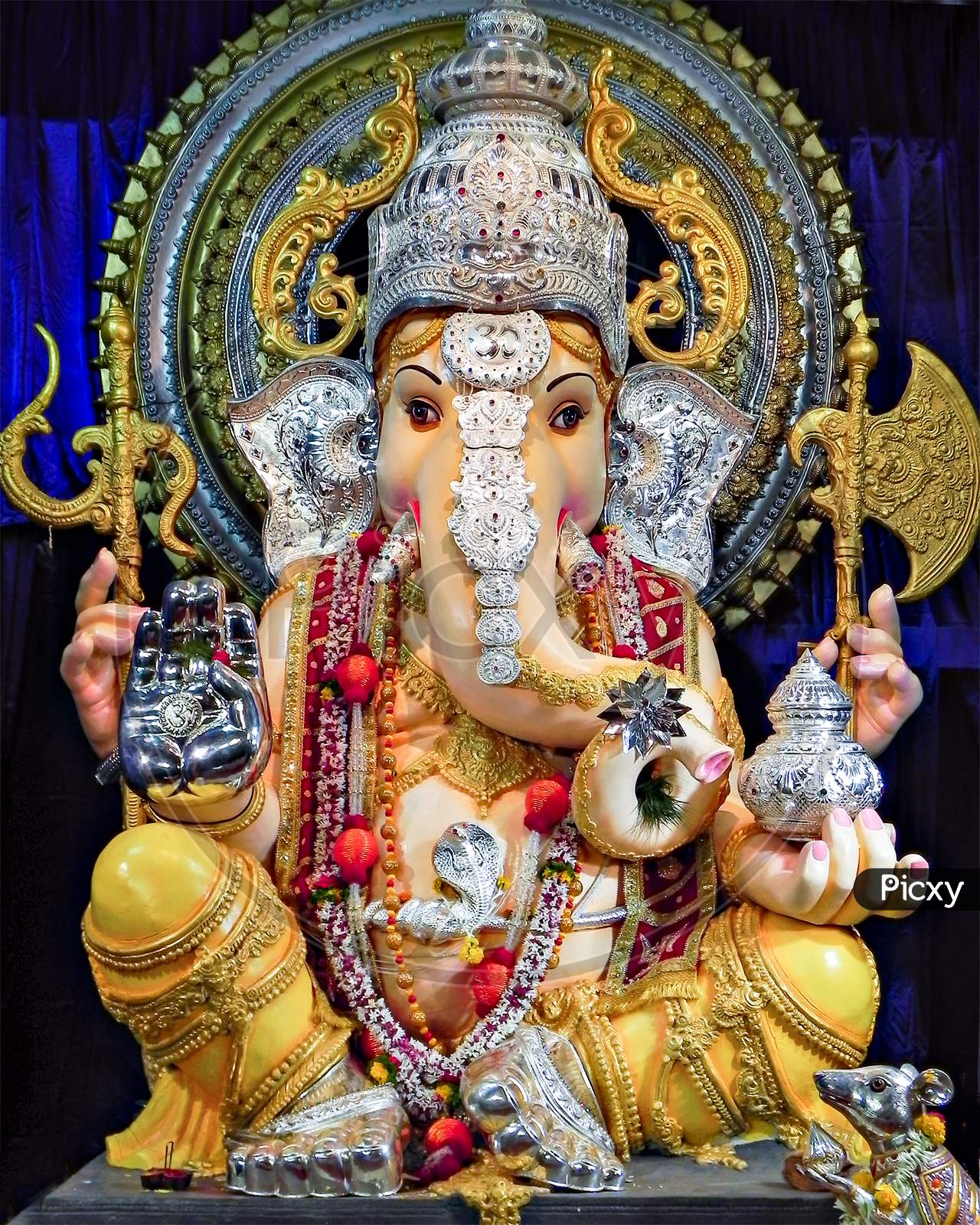 Portrait , Closeup View Of Decorated And Garlanded Idol Of Hindu God Ganesha .