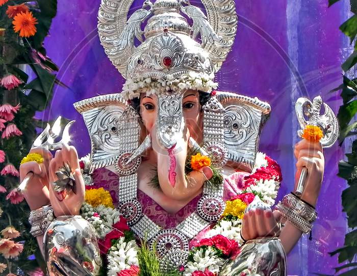 Portrait , Closeup View Of Decorated And Garlanded Idol Of Hindu God Ganesha In Pune, India.