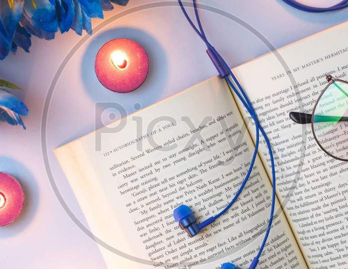 An opened book with blue headset