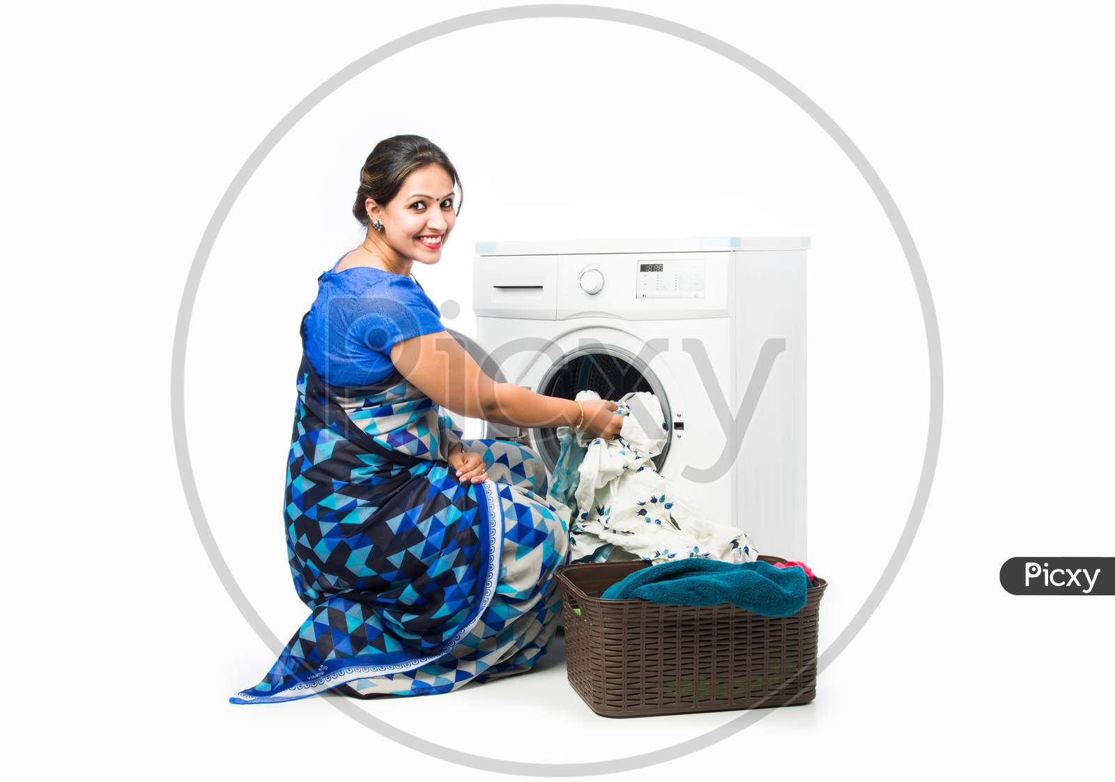 Indian Asian Housewife Washing Cloths In A Machine