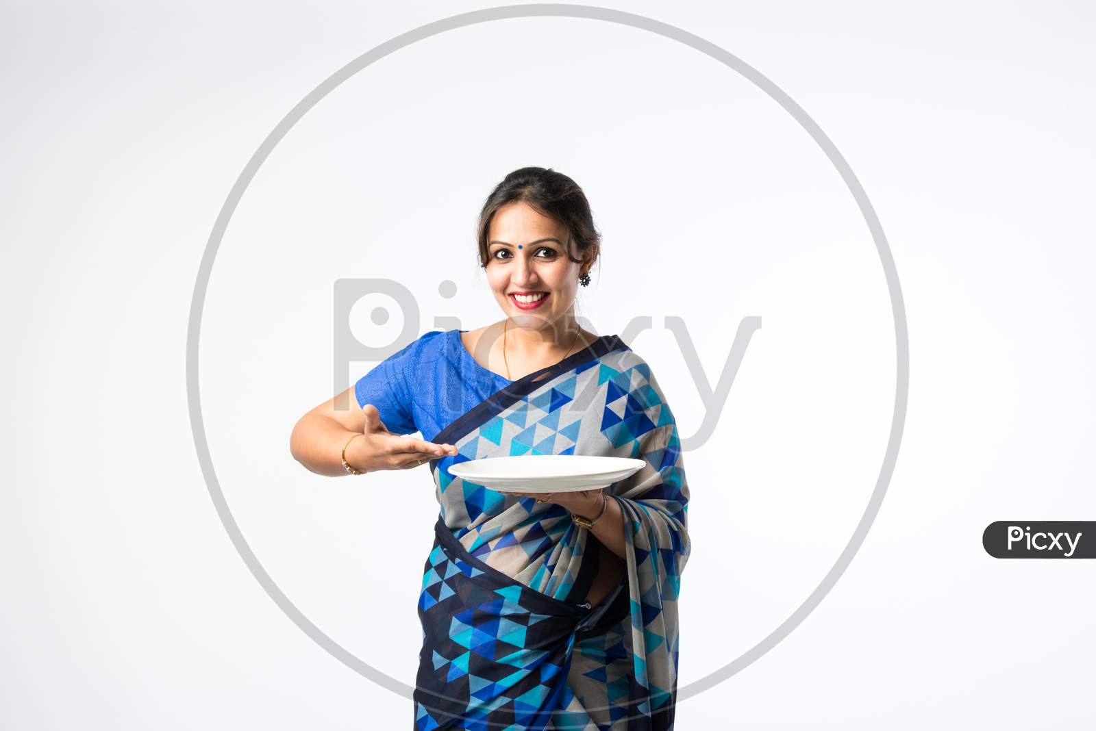 Indian Asian Woman Or Housewife Presenting White Ceramic Plate Or Bowl