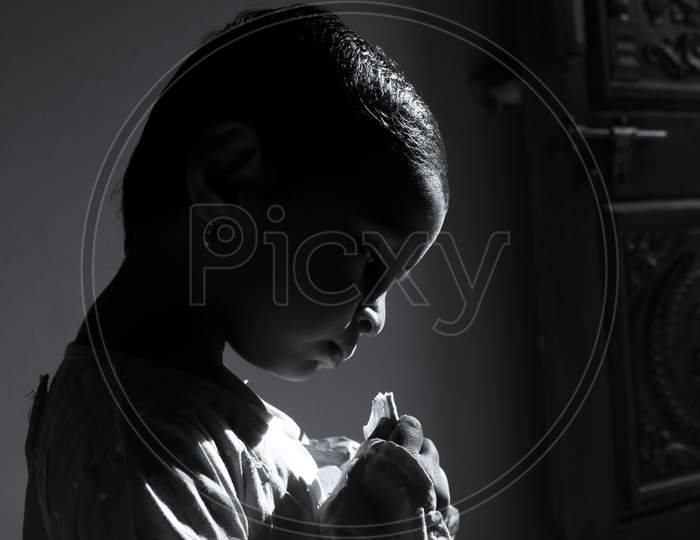 Closeup Shot Of Girl Child Enjoying Eating Biscuits In Morning Sunlight
