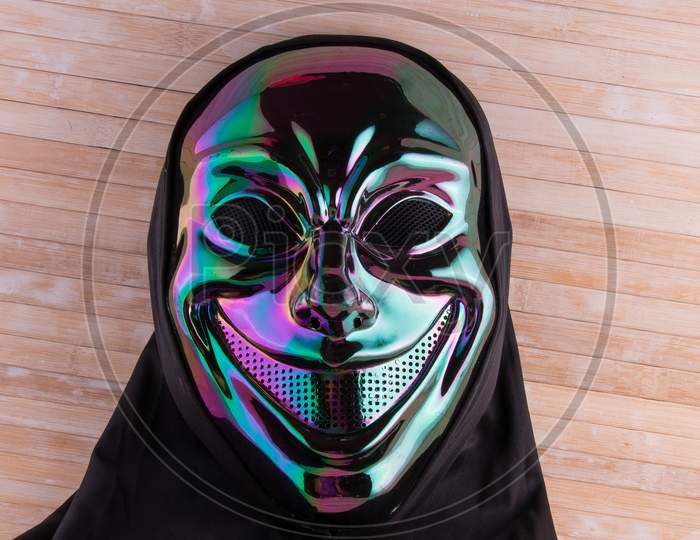 Iridescent Hooded Mask Close Up On Wooden Background