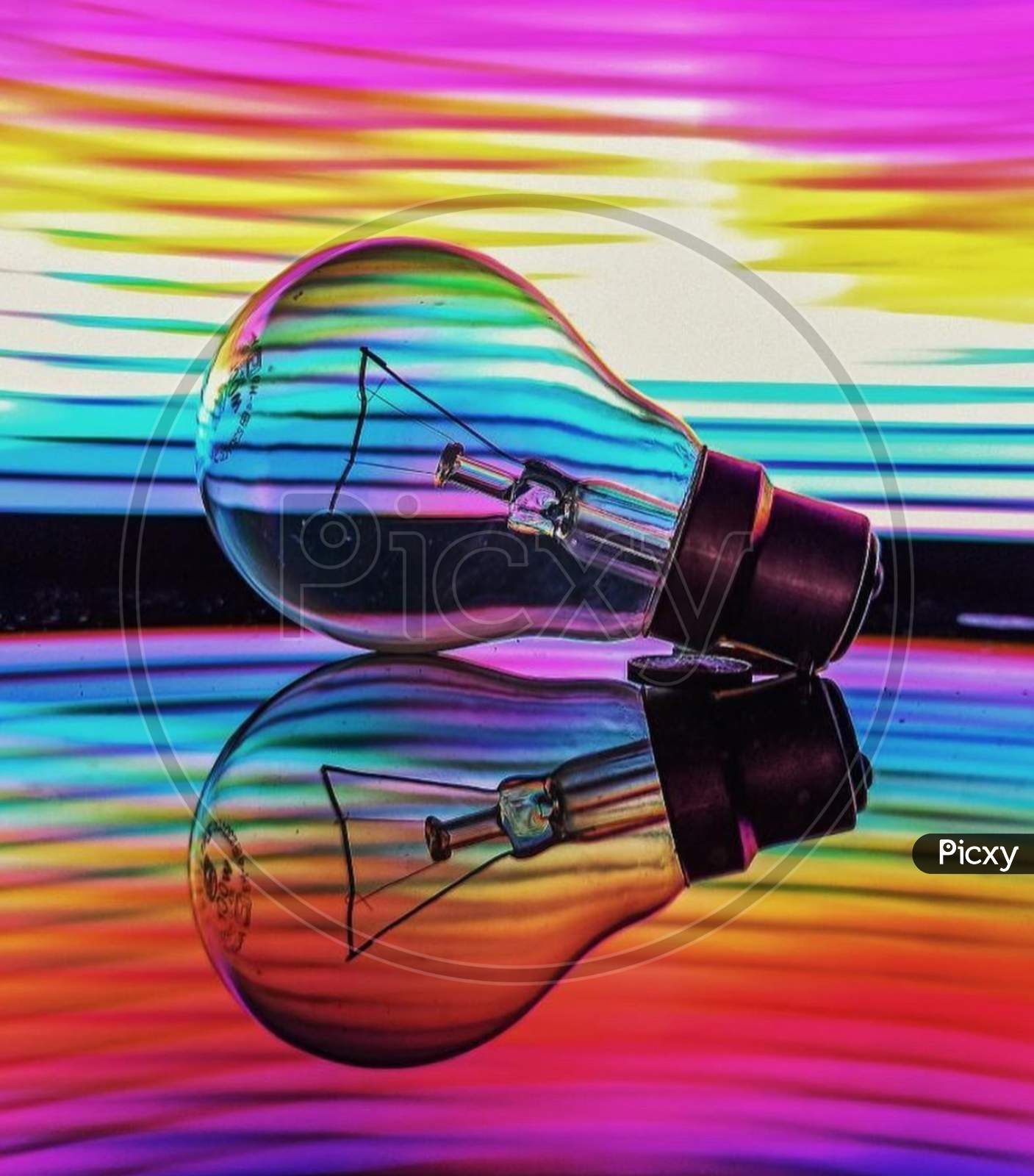 Filament bulb with background of Rainbow coloured texture