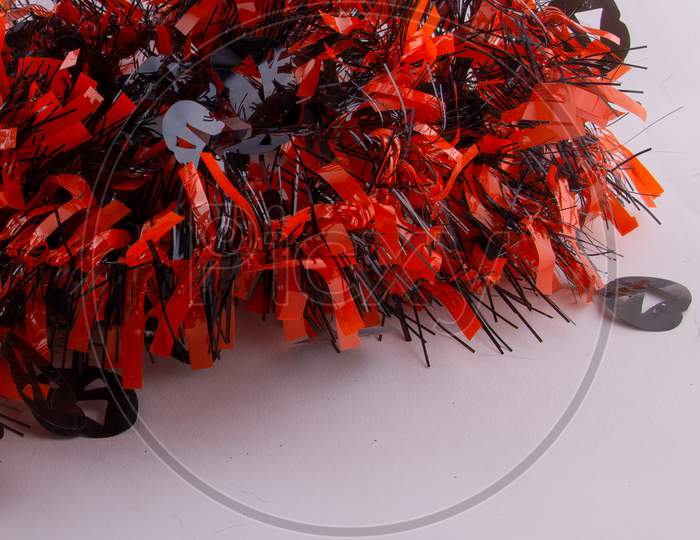 Halloween Concept Fun For Kids. Scary Tinsel In Orange And Black With Screaming Pumpkins