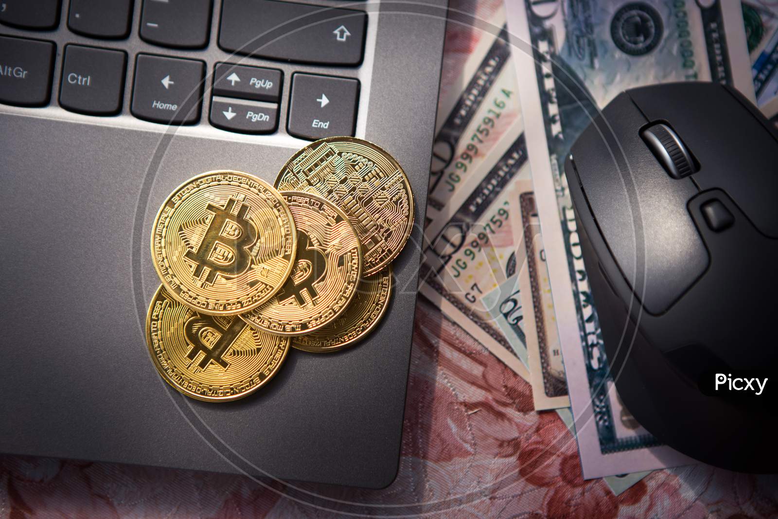 Top View Of Bitcoin Gold Coins On Laptop And Next To Us Dollar Banknotes And Computer Mouse