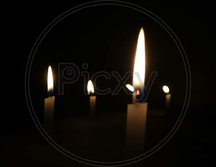 Look at how a single candle can both defy and define the darkness