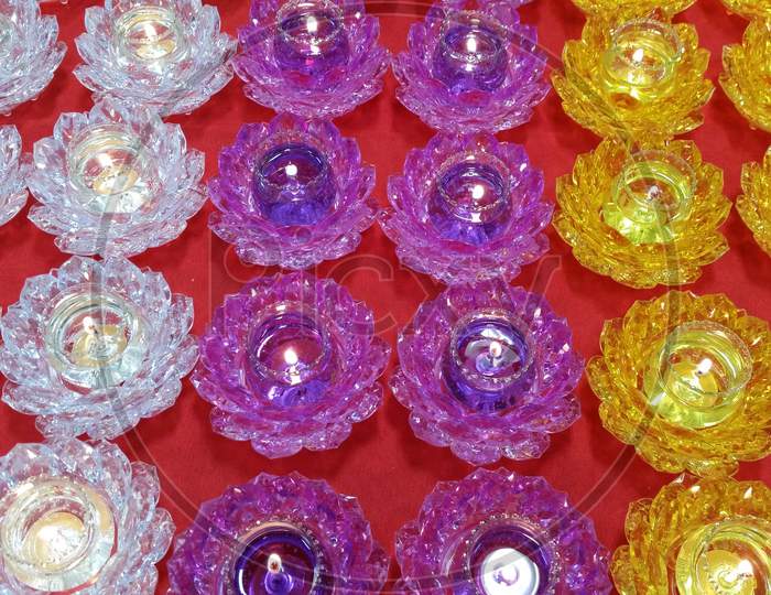 Candles in lotus flower shaped glass bowls for religious worship