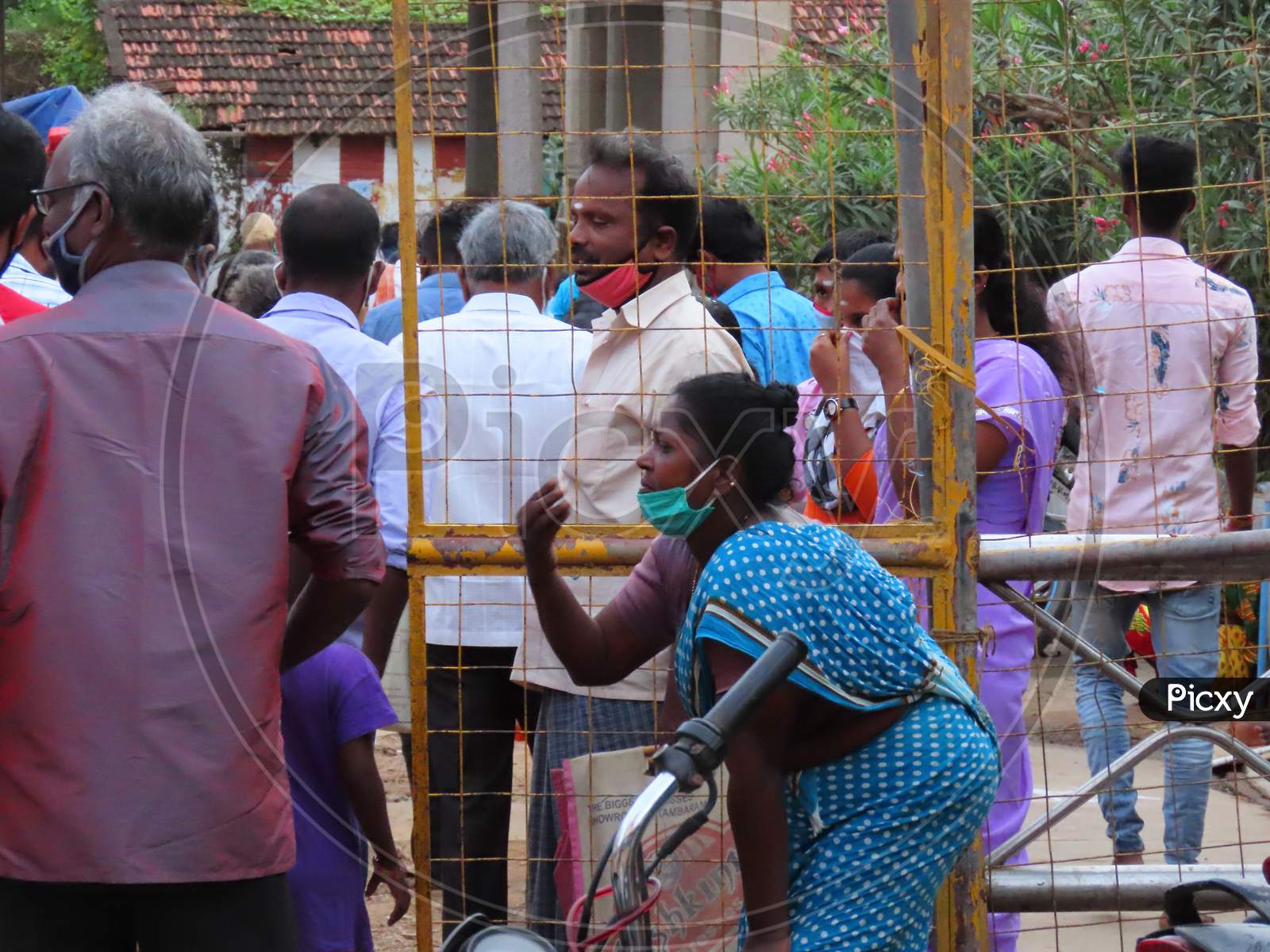 A Poor Woman Wearing A Mask To Protect The Corona At The Hindu Temple Entrance, Begging People To Eat Something Or Begging