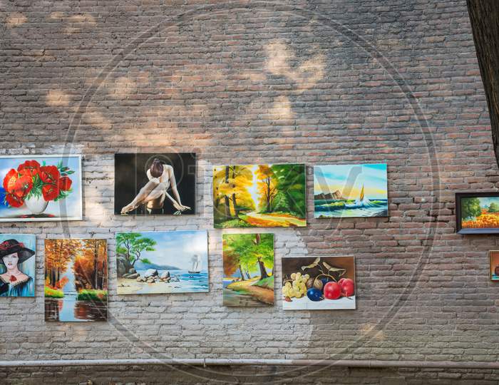 Tbilisi, Georgia - August 28, 2018: Paintings For Sale Hanged On Wall At Dry Bridge Market In Downtown Of Tbilisi. Market For Tourist Attraction, Editorial Use Only