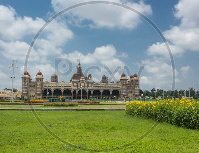 A Well manicured garden view of the Ambavilas Palace with the Clouds for the Dasara festival in Mysuru of Karnataka/India.