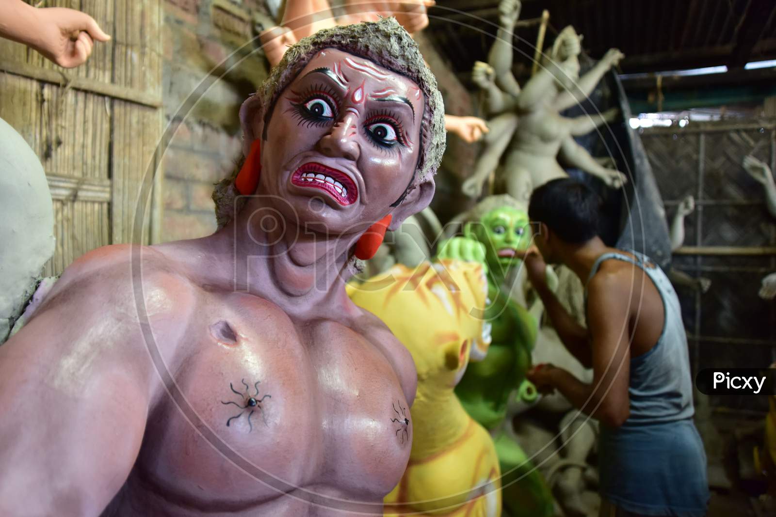 An artist finishing Asura where Durga idols are being prepared ahead of the biggest Hindu festival Durga puja in Nagaon District of Assam on Oct 9,2020