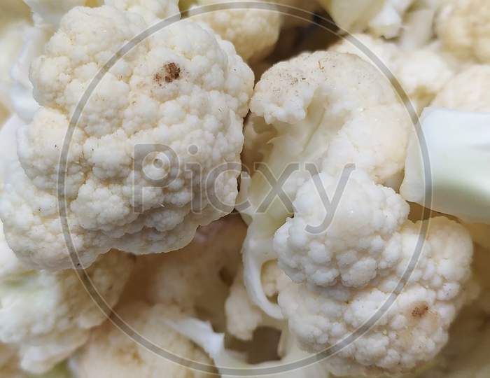 Closeup View Of Chopped And Rinsed White Cauliflower , Top View