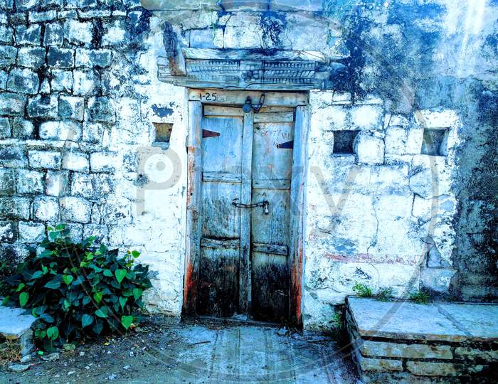 Old closed front door in village
