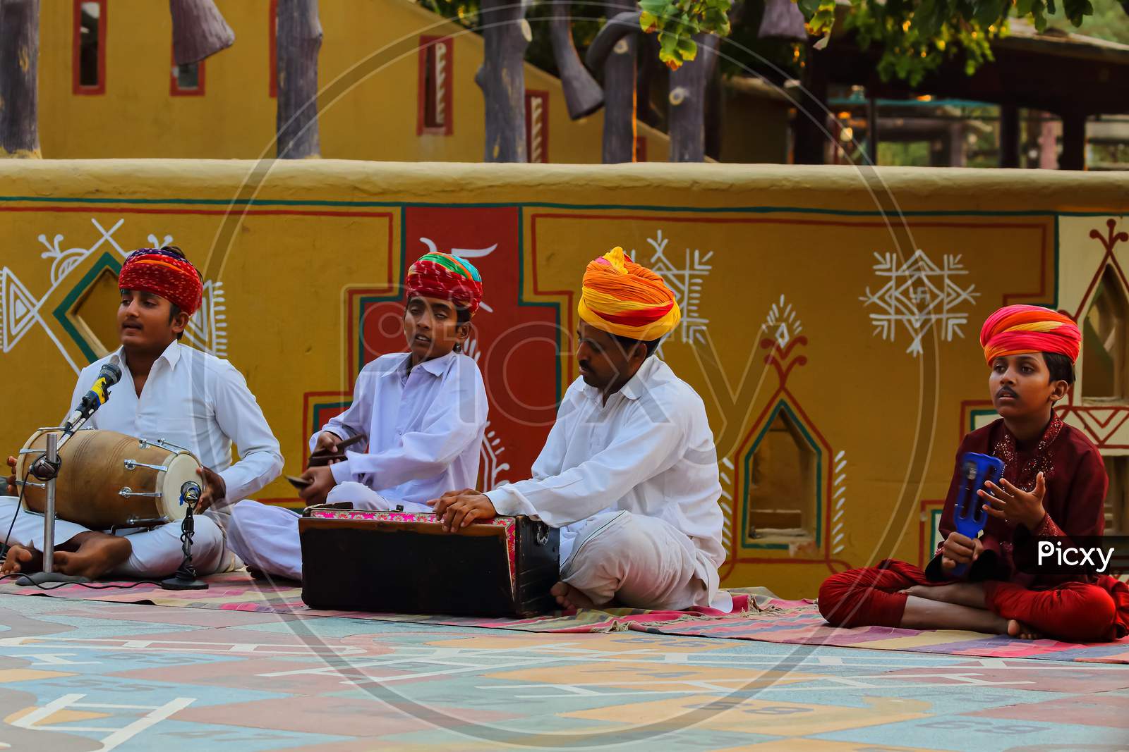 Rajasthani men dressed in traditional attire playing folk music